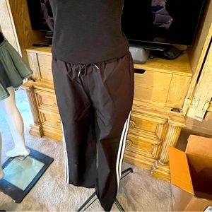 Brand New women’s sweat pants black with bright white side stripes.